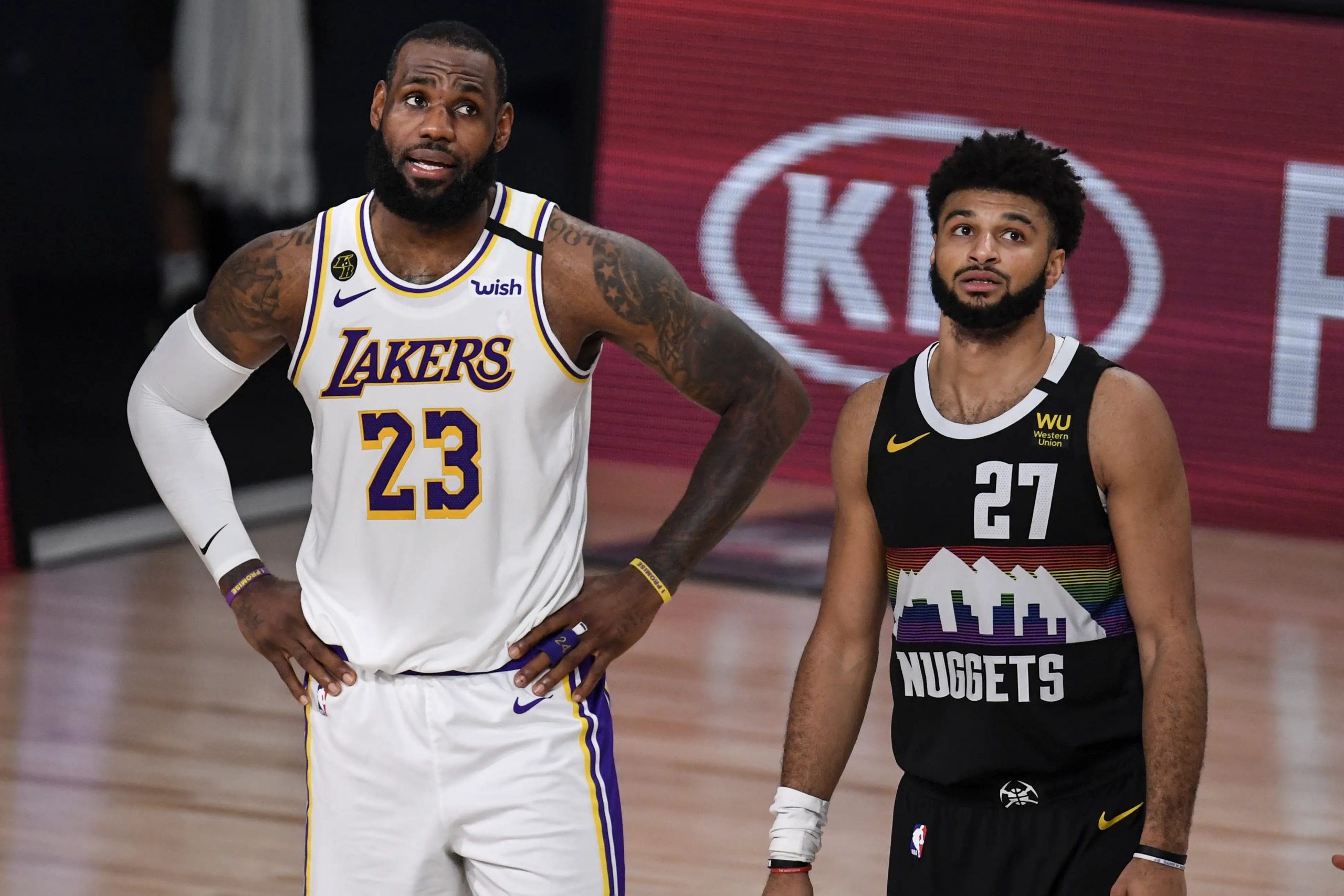 LeBron James (23) of the Los Angeles Lakers and Jamal Murray (27) of the Denver Nuggets stand for free throws during the second quarter at AdventHealth Arena at ESPN Wide World of Sports Complex in Orlando
